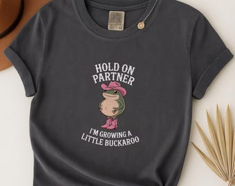 Hold On Partner I'm Growing A Little Buckaroo Funny Pregnancy Announce T-Shirt, Cowboy Frog Baby Reveal Western New Mom Gift, Cowgirl Unisex