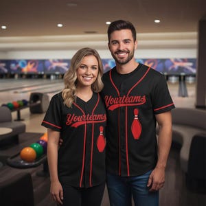 May include: Two people wearing black baseball jerseys with red trim. The jerseys feature the text "Yourteams" in red script and a red bowling pin graphic. The button-down jerseys have red piping and are short-sleeved.