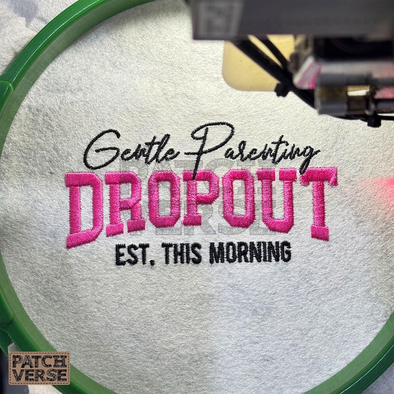 Gentle Parenting Dropout flat embroidery machine design featuring bold varsity lettering with script overlay stitched on a hat hoop setup. Funny mom life cap embroidery file perfect for dad hats, snapbacks and trucker hats. Digital embroidery design available in PES DST EXP VP3 HUS JEF XXX SEW formats for clean professional hat embroidery production..
