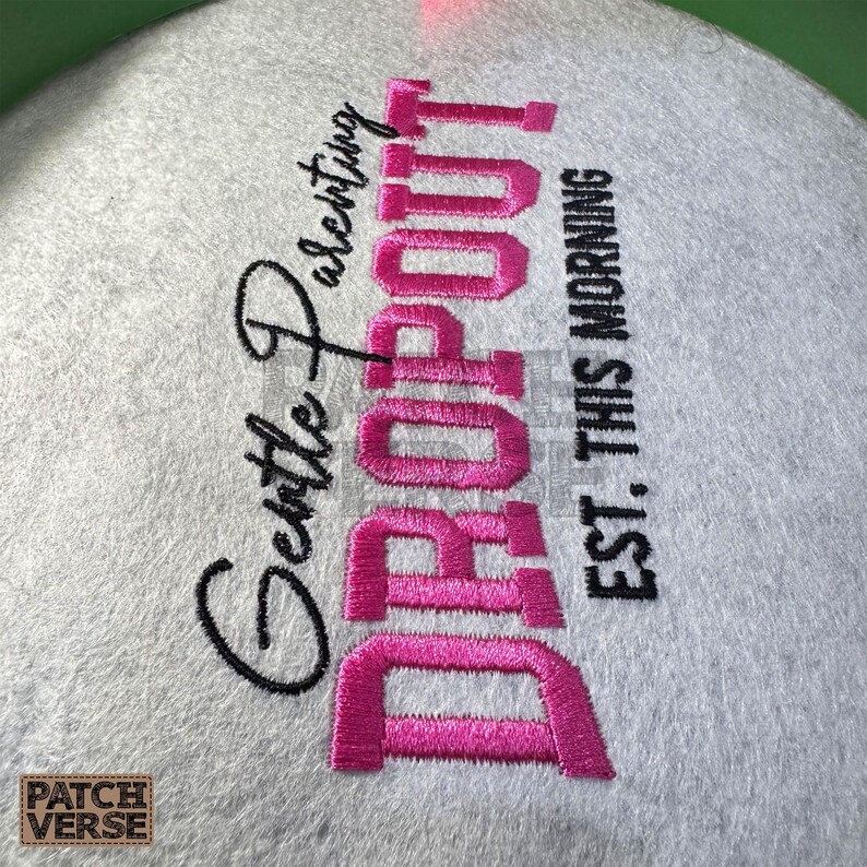 Gentle Parenting Dropout flat embroidery machine design featuring bold varsity lettering with script overlay stitched on a hat hoop setup. Funny mom life cap embroidery file perfect for dad hats, snapbacks and trucker hats. Digital embroidery design available in PES DST EXP VP3 HUS JEF XXX SEW formats for clean professional hat embroidery production..