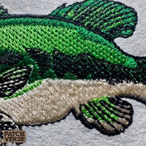 Bass fish embroidery design file stitched in a realistic largemouth bass style, professionally digitized for hats and caps. This fishing embroidery file is optimized for dad hats, trucker hats, and snapback caps, featuring clean outlines and smooth fills for outdoor, angler, and fishing brand projects. Perfect for machine embroidery on fishing hats, custom caps, and 
outdoor apparel.