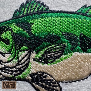 Bass fish embroidery design file stitched in a realistic largemouth bass style, professionally digitized for hats and caps. This fishing embroidery file is optimized for dad hats, trucker hats, and snapback caps, featuring clean outlines and smooth fills for outdoor, angler, and fishing brand projects. Perfect for machine embroidery on fishing hats, custom caps, and 
outdoor apparel.