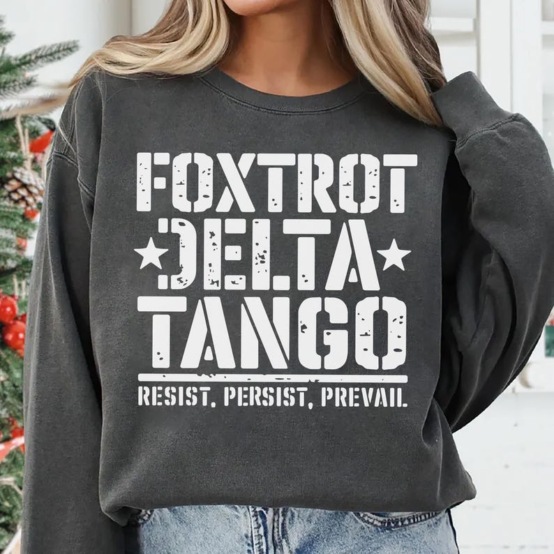 May include: A dark gray sweatshirt with the text "FOXTROT DELTA TANGO" in white, with the words "RESIST. PERSIST. PREVAIL." below.
