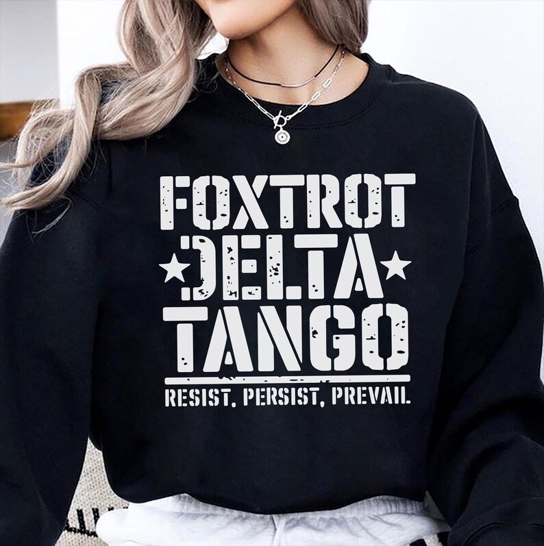 May include: Black sweatshirt with white text that reads "FOXTROT DELTA TANGO" and "RESIST. PERSIST. PREVAIL."