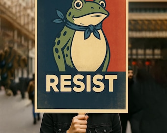 May include: A poster featuring a cartoon frog with a blue neckerchief against a red and blue background. The word "RESIST" is printed in large white letters below the frog. The poster is held up by a person in a black jacket.