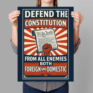 May include: A poster with a red, white, and blue color scheme. It features a stylized image of a fist holding a document with the text "We the People" and the words "Defend the Constitution from all enemies both foreign and domestic".