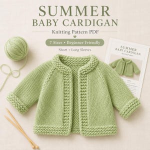 May include: A light green knitted baby cardigan with a garter stitch border and cuffs, accompanied by a ball of matching yarn, two knitting needles, and a printed pattern document titled SUMMER BABY CARDIGAN Knitting Pattern PDF.