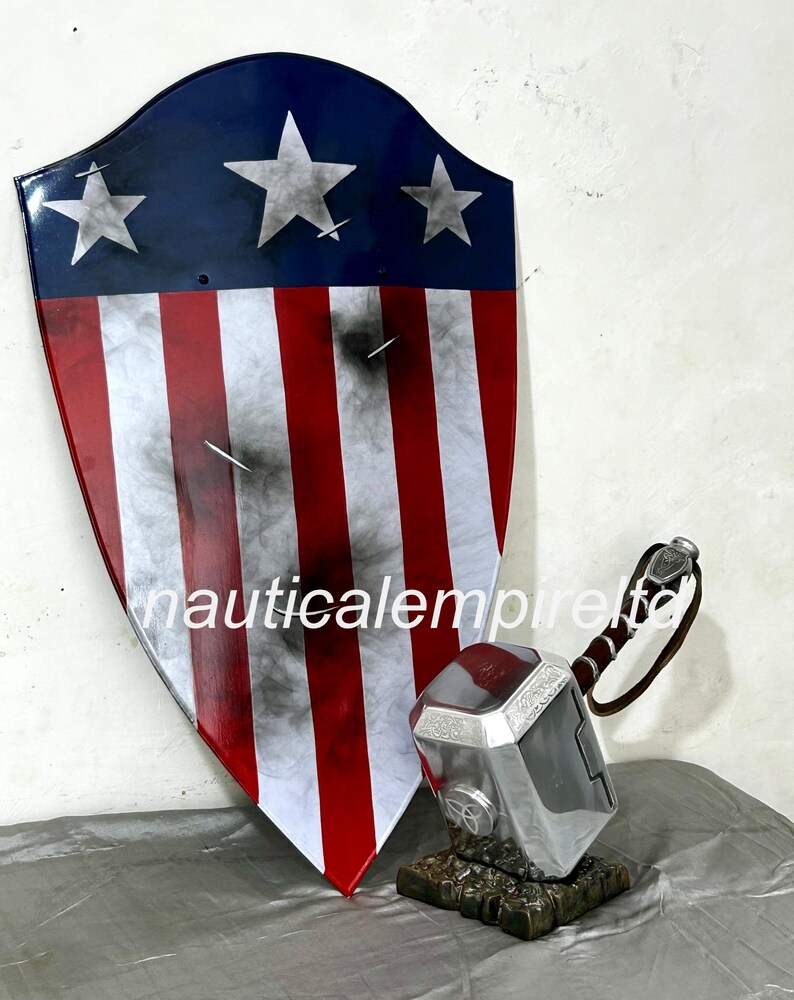 May include: A red, white, and blue shield with five white stars, a distressed look, and a silver hammer with a brown leather handle.