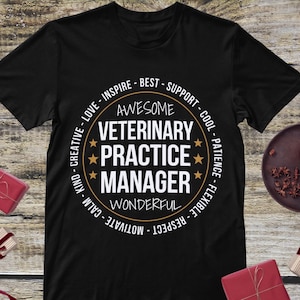 May include: Black t-shirt with a circular design featuring the text "AWESOME VETERINARY PRACTICE MANAGER" in white and gold. The design includes stars and words like "LOVE", "INSPIRE", and "SUPPORT".
