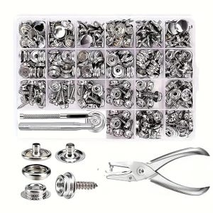 May include: A clear plastic organizer filled with various silver metal snap fasteners, including studs, sockets, and screws. Also includes a setting tool and a snap setter tool. A set of snap fasteners and a hole punch tool are displayed below the organizer.