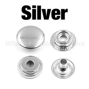 May include: Four silver snap fasteners, including a cap, socket, stud, and eyelet. The word "Silver" is printed in bold, black letters at the top. These metal snaps are designed for various sewing and crafting projects.