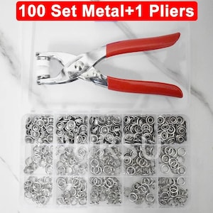 May include: A set of metal snap fasteners and pliers. The pliers have red handles and a silver metal body. The fasteners are organized in a clear plastic container with multiple compartments. The text "100 Set Metal+1 Pliers" is displayed in a red banner.