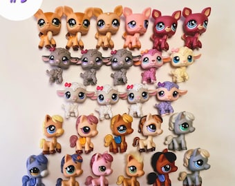 May include: A collection of colorful, small animal figurines, including deer, sheep, and horses. The figurines have large eyes and are in various colors, such as brown, pink, and gray. The number "#9" is in the upper left corner.