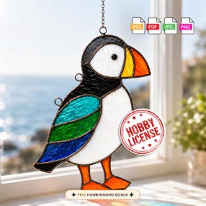May include: A stained glass puffin suncatcher featuring a black, white, and orange beak, a white face, and a wing with teal, green, and blue glass segments. The bird has orange feet and a metal chain for hanging. Includes SVG, PDF, JPG, PNG icons.