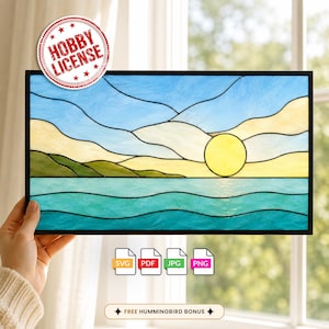 May include: A rectangular stained glass panel featuring a landscape scene with a bright yellow sun, light blue sky, rolling hills in shades of green and cream, and turquoise water. A red circular badge reads HOBBY LICENSE. File icons for SVG, PDF, JPG, and PNG are visible.