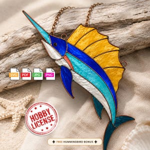 May include: A stained glass sailfish suncatcher featuring vibrant blue, turquoise, white, and yellow glass panels held together by copper-colored metal solder lines. The fish is suspended by a metal chain and includes a circular hobby license badge.