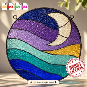 May include: A circular stained glass panel featuring a crescent moon set against a night sky of deep blue and purple, with wavy bands of teal, turquoise, and gold below. The piece is framed in black metal and includes a red circular hobby license seal.