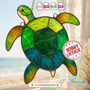 May include: A stained glass sea turtle suncatcher featuring a gradient of green, teal, and amber textured glass panels held together by dark metal solder lines. The design includes a circular red stamp with the text HOBBY LICENSE.