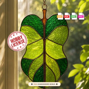 May include: A stained glass leaf suncatcher featuring shades of emerald and lime green glass with dark metal soldering. A circular red stamp reads HOBBY LICENSE. Icons for SVG, PDF, JPG, and PNG are visible. A banner reads FREE HUMMINGBIRD BONUS.