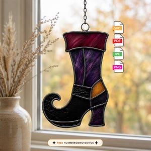 May include: A stained glass suncatcher shaped like a witch's boot with a dark red cuff, a purple leg, a black foot, and a small orange accent piece. The piece hangs from a metal chain and includes digital file icons labeled SVG, PDF, JPG, and PNG.
