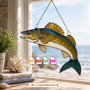 May include: A stained glass suncatcher shaped like a fish with yellow, teal, and cream-colored glass panels held together by dark metal solder lines. The fish is suspended by a thin metal chain and features four file format icons: SVG, PDF, JPG, and PNG.
