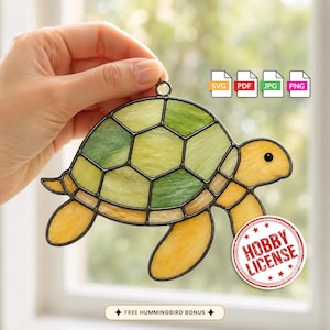 May include: A stained glass turtle suncatcher featuring a shell with green and yellow glass segments outlined in black metal. The turtle has a yellow head and flippers. A red circular stamp reads HOBBY LICENSE, and icons for SVG, PDF, JPG, and PNG are visible.