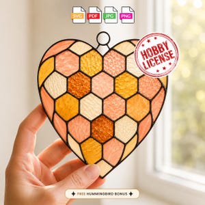 May include: A heart-shaped stained glass suncatcher featuring a honeycomb pattern in shades of orange, yellow, and peach, outlined in black metal. The image includes icons for SVG, PDF, JPG, and PNG file formats, a Hobby License stamp, and text.