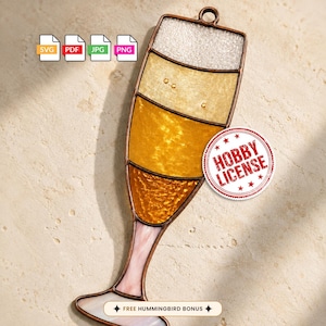 May include: A stained glass champagne flute ornament with a copper frame. The glass features a white textured top, followed by light gold, medium gold, and dark amber sections. Includes SVG, PDF, JPG, PNG icons and a red Hobby License stamp.