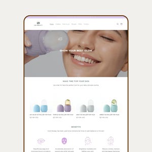 May include: A website interface for LB Beauty featuring a lavender ice roller for the face. The page displays the text SHOW YOUR BEST GLOW and showcases four different colored ice rollers in blue, purple, gray, and green with product names.