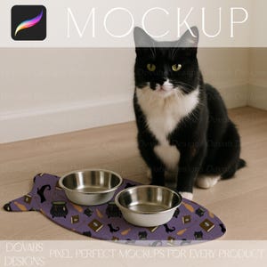 May include: A black and white cat sits near a purple pet feeding mat with two stainless steel bowls. The mat features a pattern of witch-themed icons. The word "MOCKUP" is at the top of the image. The text "DOVAHS DESIGNS" is at the bottom.