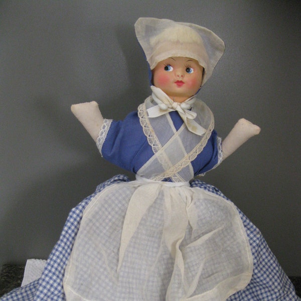 Vintage 1950's Hand Made Toaster Cover Doll. Measures About 18" T.Has Celluloid Face, Wood Base. Blue Gingham Dress, White Apron. Few Stains