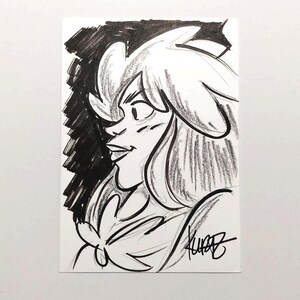 May include: A black and white sketch of a woman's face in profile. The drawing features a stylized depiction of hair and facial features, with a dark, shaded background. The artist's signature is visible in the lower right corner.