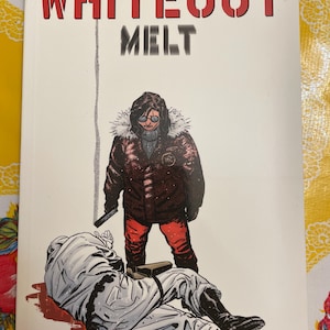 May include: Comic book cover for "Whiteout: Melt" by Greg Rucka and Steve Lieber. The cover features a person in a red and black winter coat standing over a person in a white snowsuit. The title is in large red letters.