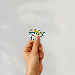 Holding a sticker of belfast giants ice hockey team logo on a white background