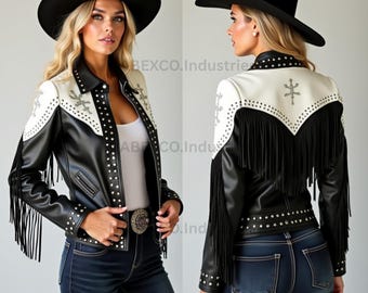 May include: Black and white leather jacket with fringe and studded details. The jacket has a white yoke with embroidered accents and a black collar. A black cowboy hat completes the look. The jacket is worn with blue jeans.