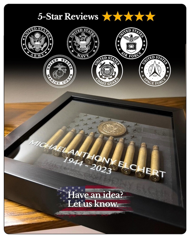 May include: A black shadow box frame containing a row of brass bullet casings, a circular military medallion, and a dark flag background. The glass is printed with the text MICHAEL ANTHONY ELCHERT 1944-2023. Above are six circular military branch logos.
