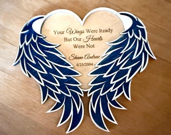 May include: Wooden heart-shaped memorial plaque with blue wings and the text "Your wings were ready but our hearts were not. Shane Andrew 4/25/2004."