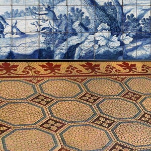 May include: Blue and white ceramic tiles depicting a pastoral scene with figures and animals. Below, a decorative border with red and gold leaf patterns. The floor features a mosaic design with hexagonal shapes in beige, blue, and red.