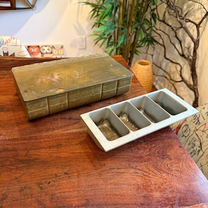 May include: A set of three ceramic mugs with a speckled, matte finish. The mugs are in shades of cream, light gray, and dark gray. Each mug has a simple, minimalist design and a rounded handle. Perfect for coffee or tea.