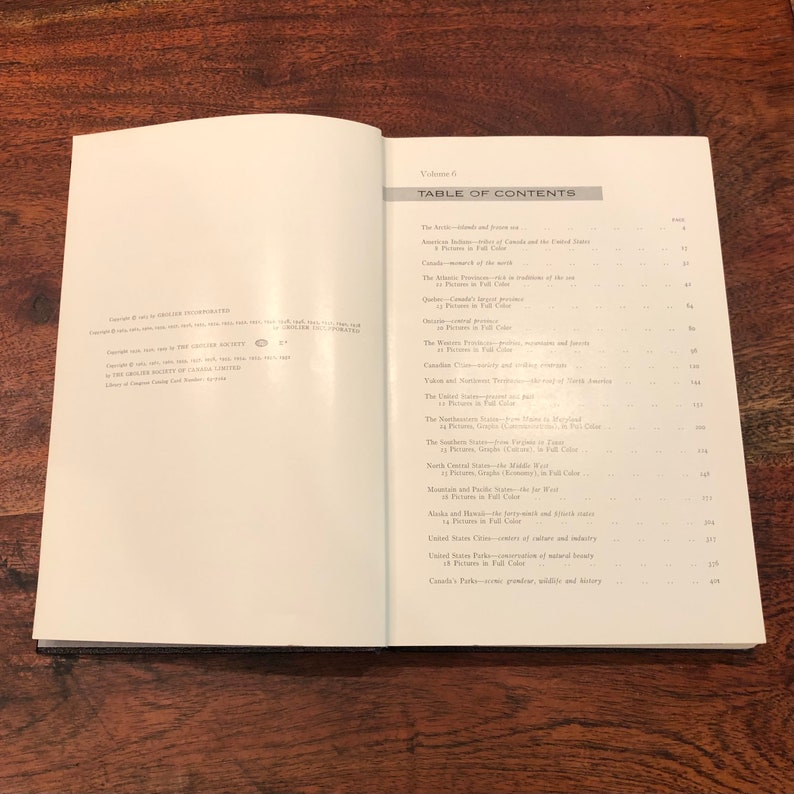 May include: A black and white book with a white cover and black text. The title of the book is "Table of Contents" and the text lists the different chapters of the book. The book is open to a page with the chapter titles "The Arctic-Islands and Frozen Sea" and "American Indians- tribes of Canada and the United States".