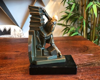 Antique c. 1930 Art Deco Bronze & Celluloid Falling Books and Colonial Man Bookend by John Ruhl Designed for the J.B. Hirsch Co. New York