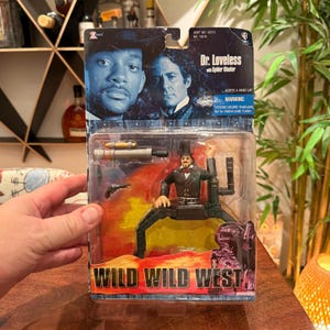 May include: A Wild Wild West Dr. Loveless action figure in original blister packaging. The set includes a Dr. Loveless figure with mechanical spider legs, a spider blaster, and a small pistol. The card features images of the movie characters.