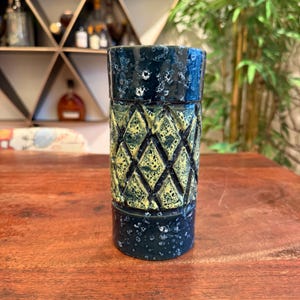 May include: A set of three ceramic mugs with a speckled, matte finish. The mugs are in shades of cream, light gray, and dark gray. Each mug has a simple, minimalist design, perfect for coffee or tea.