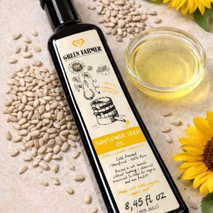 K&ouml;nnte beinhalten: Eine schwarze Flasche Sonnenblumenkern&ouml;l mit einem Etikett mit einer Sonnenblumenillustration und dem Text "Green Farmer". Die Flasche ist umgeben von Sonnenblumenkernen, einer kleinen Sch&uuml;ssel &Ouml;l und Sonnenblumen. Die Flasche enth&auml;lt 250 ml.