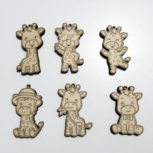 May include: Six laser-cut wooden giraffe ornaments featuring various poses and accessories. The light-colored wood pieces display engraved details including a giraffe wearing sunglasses, a hat, a bow tie, and one holding leaves, each with a small hole at the top.