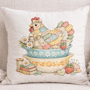 May include: A cushion with a charming illustration of a patchwork chicken on floral bowls. The design includes daisies, strawberries, spools of thread, and buttons, creating a country-themed aesthetic. The cushion is on a white background.