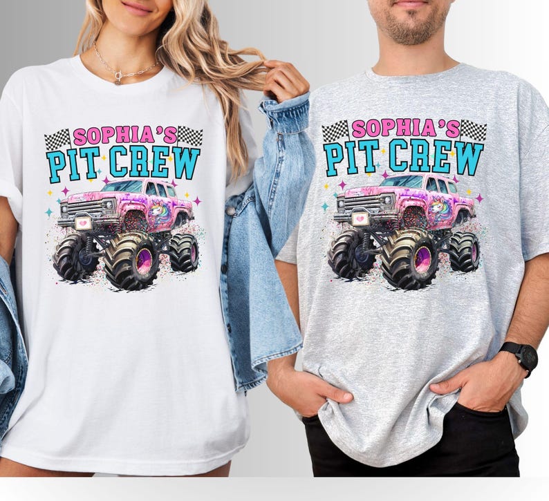 May include: White and gray t-shirts featuring a colorful graphic of a pink monster truck with a unicorn design. The text "SOPHIA'S PIT CREW" is printed above the truck in blue and pink, with a checkered flag design. The shirts are worn by two people.