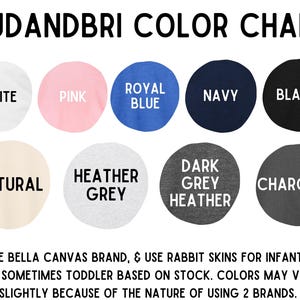 May include: Color chart displaying various fabric colors, including white, pink, royal blue, navy, and black. Additional colors are natural, heather grey, dark grey heather, and charcoal. Text at the bottom states the brands used.