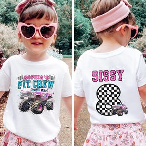 May include: White t-shirt with a colorful monster truck graphic and the text "SOPHIA'S PIT CREW" on the front. The back of the shirt features the name "SISSY" above a checkered number 8 and a monster truck.