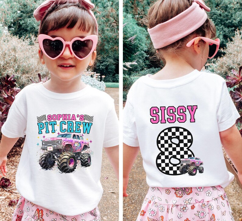 May include: White t-shirt with a colorful monster truck graphic and the text "SOPHIA'S PIT CREW" on the front. The back of the shirt features the name "SISSY" above a checkered number 8 and a monster truck.